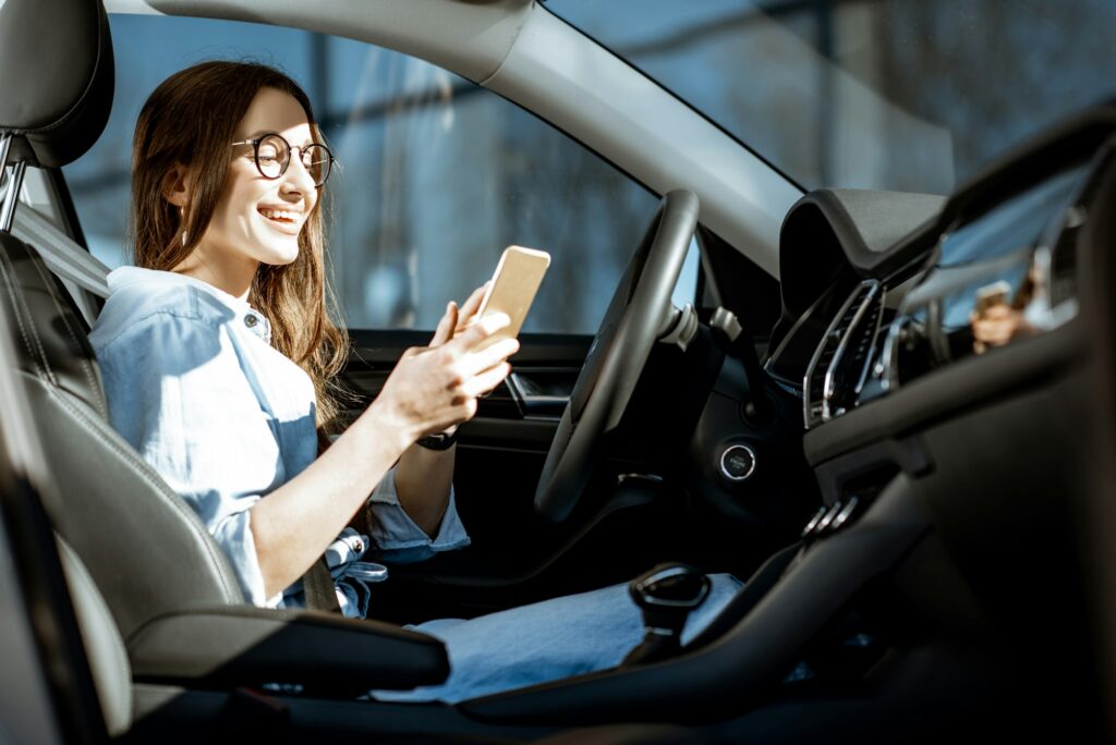 Woman with phone in the car